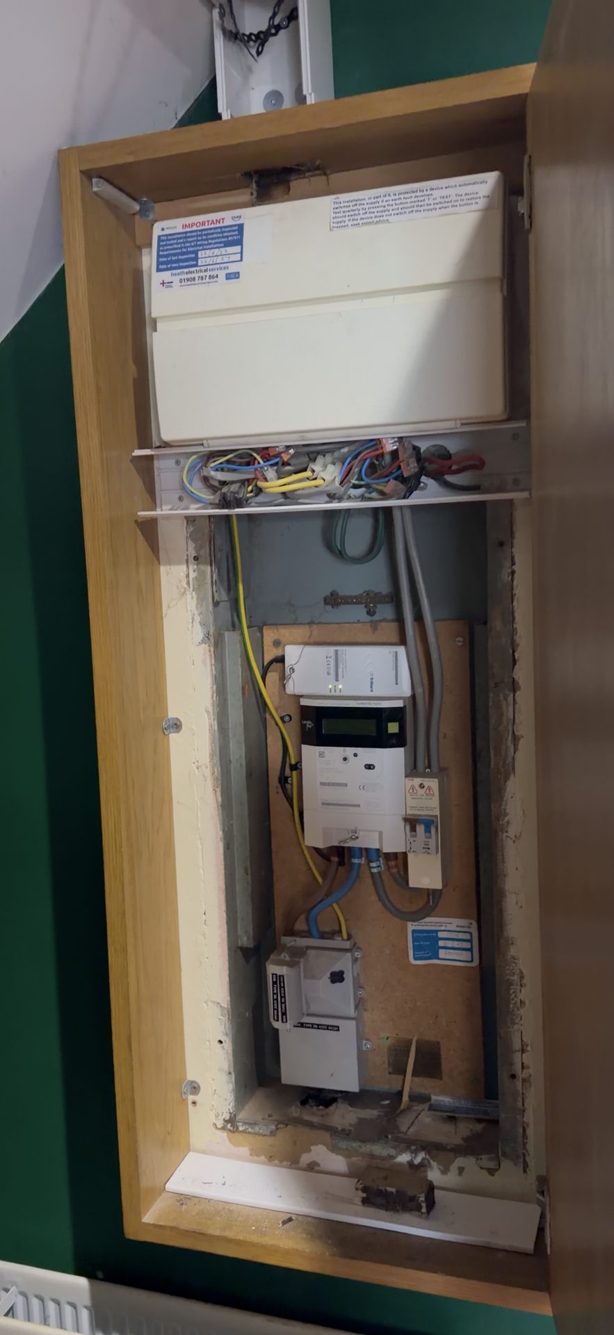 Old fusebox in original cupboard location before relocation — Hinton Electrics